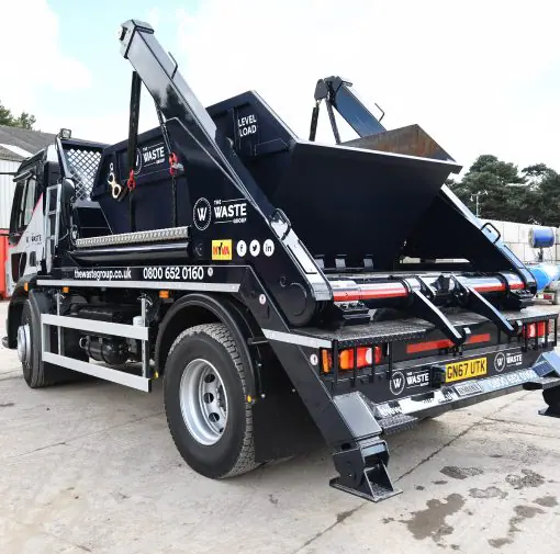 black skip on lorry